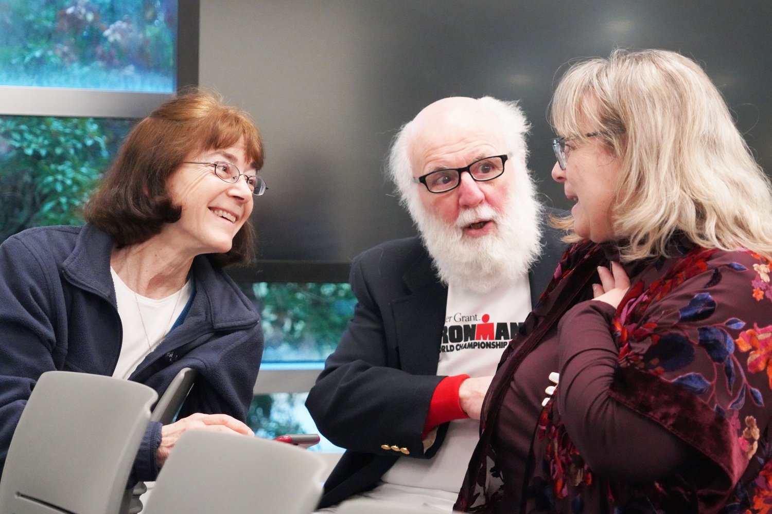 Robert Blais speaks with several members of the RWU community, including University Archivist Heidi Benedict.