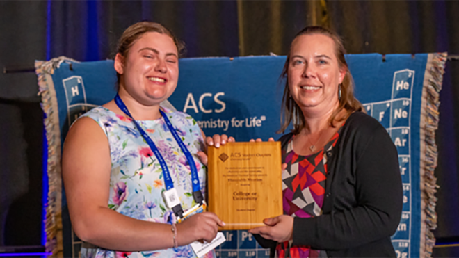 Junior Abby Heroux receives an award on behalf of RWU's Science Alliance club.