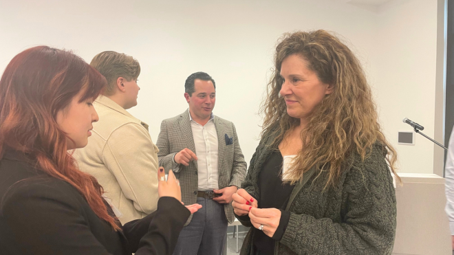 Stephanie Noris ’92, a member of RWU's Board of Advisors, speaks with one of the student leader attendees.