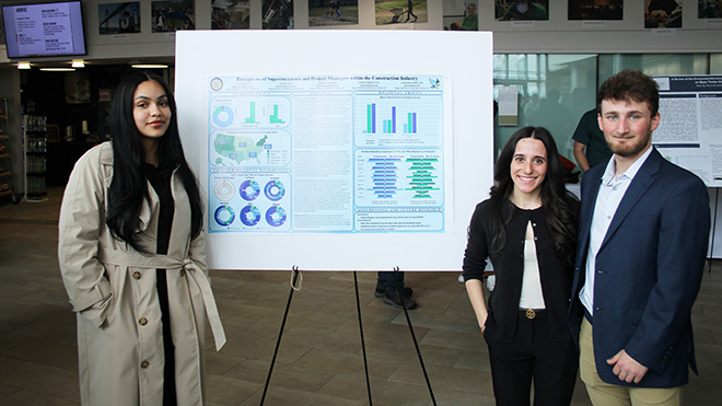 Three seniors with their poster on exploring careers in Construction Management