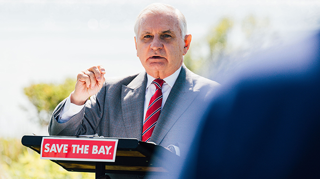 U.S. Sen. Jack Reed speaking at a podium at Save The Bay headquarters