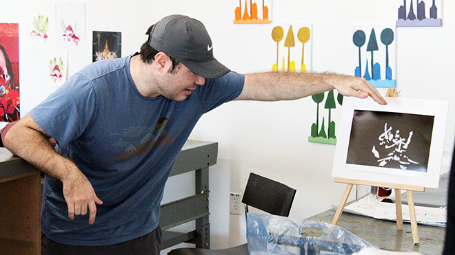 A Visual Arts student displays his work in the newly renovated Visual Arts space in North Res building