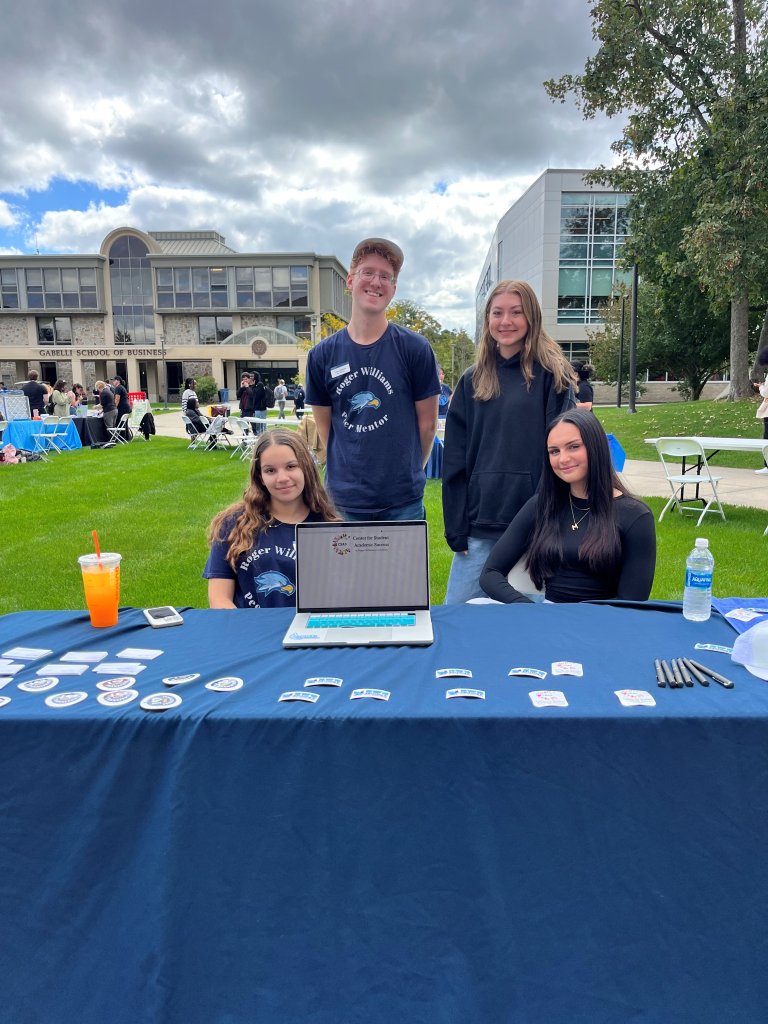 group of peer mentors sitting behind a table advertising CSAS