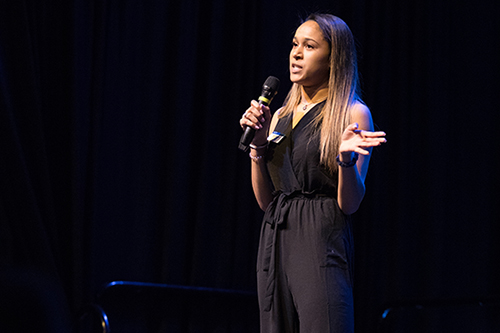 Students speaking to audience with microphone