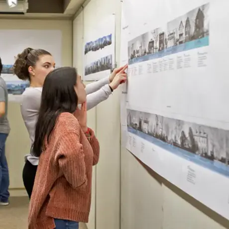 Two students discussing their architecture work