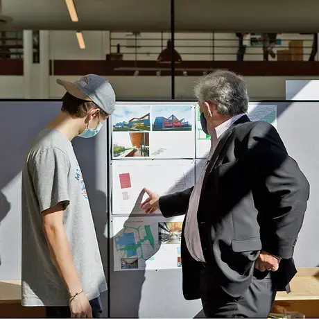 A student and a Dean discussing their project in studio