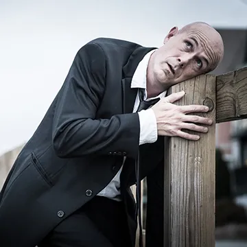 Andy Russ leans on a fence