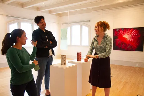People discussing art in exhibit.
