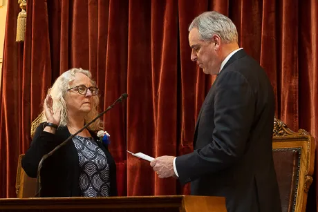 Speakman raises hand to swear in.