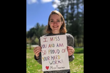 Student holding up sign.