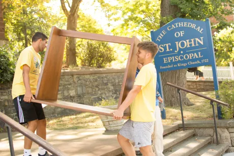 Students help move items from a church