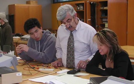 A professor works with students.