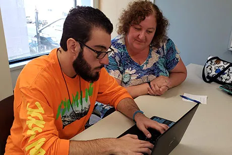 Son and mother apply to School of Continuing Studies on computer.