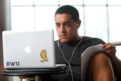 image of RWU student working remotely on laptop