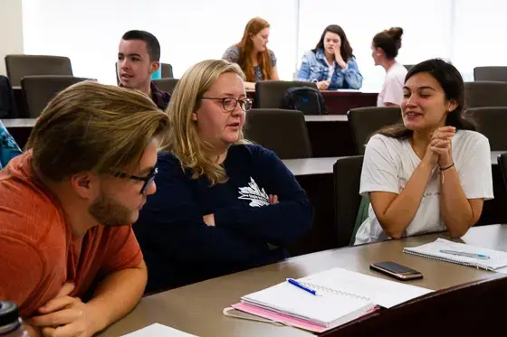 Students discuss in small groups.
