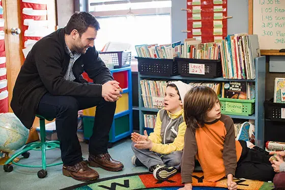 Student teacher talking to students.