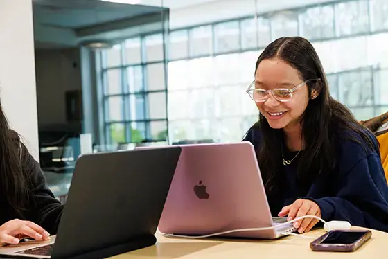 Students writing on laptops