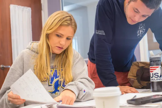 A Roger Williams University student sits reviewing some paperwork