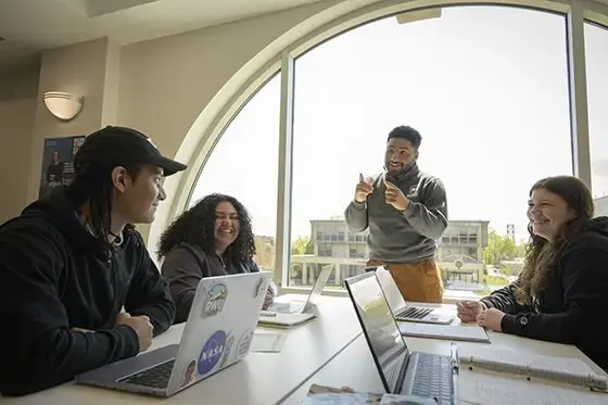 Four students work together
