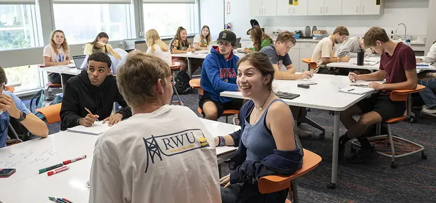 An RWU classroom with students talking and working together