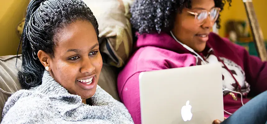 Two students working on their laptops