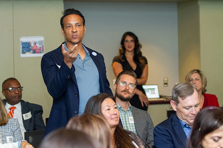 A man standing up and asking a question during a workshop at CVS headquarters