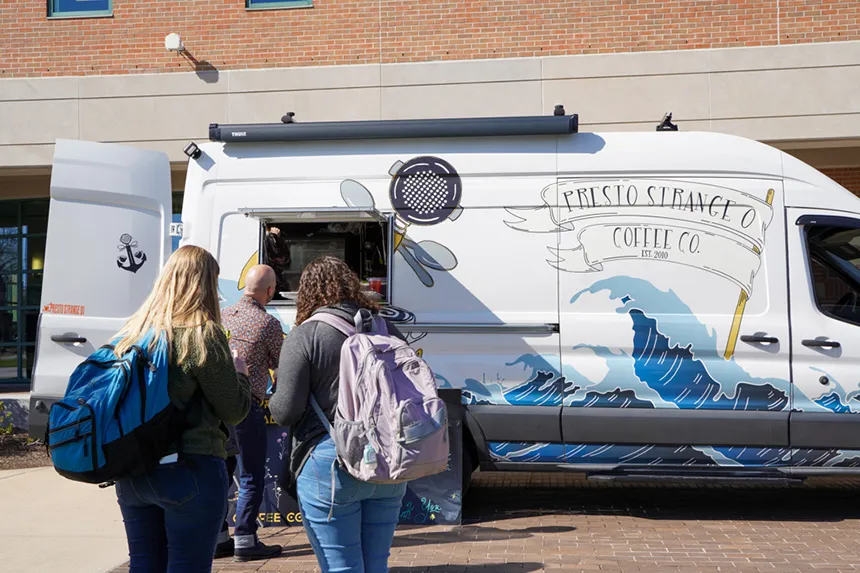 People wait in line for the Presto Coffee truck. 