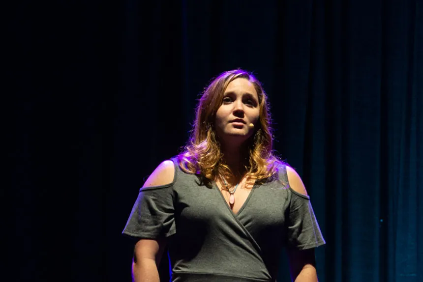 Student performs a song.
