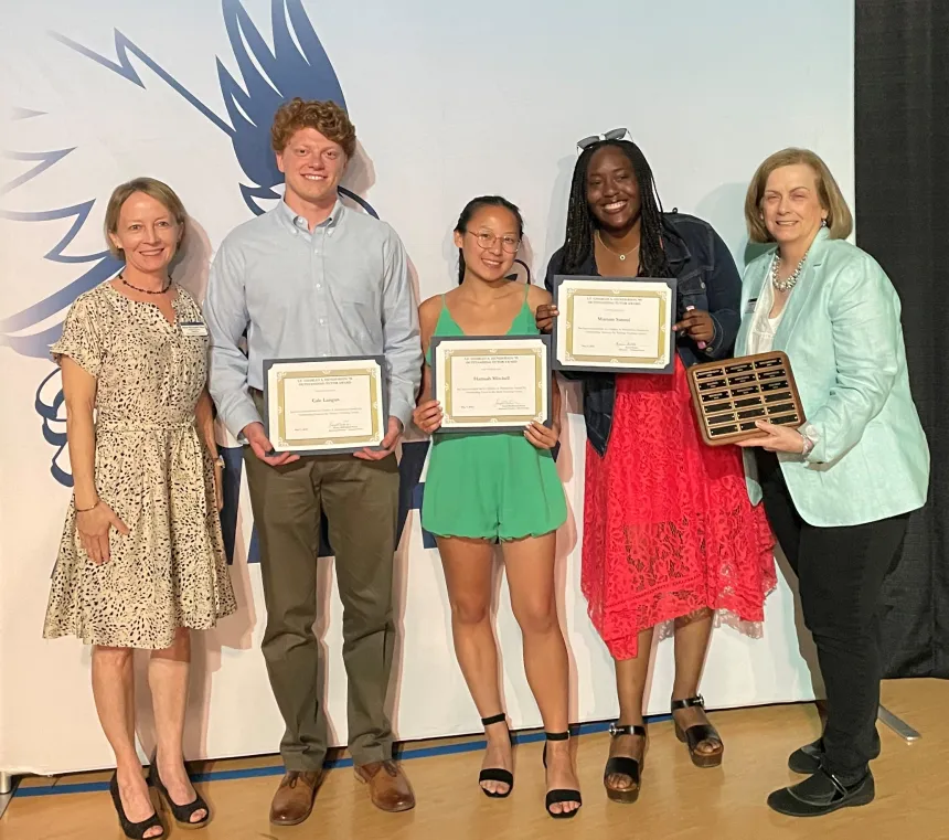 Henderson Outstanding Tutors for 2023 pose inside holding certificates