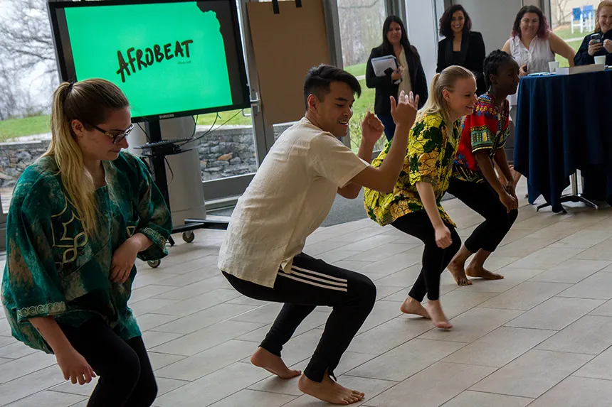Four students dancing.