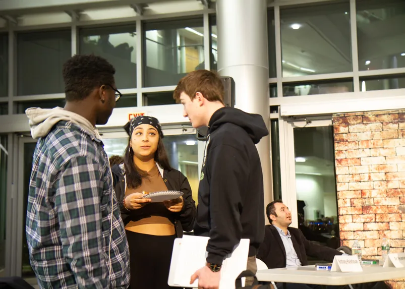 A group of students chat. 