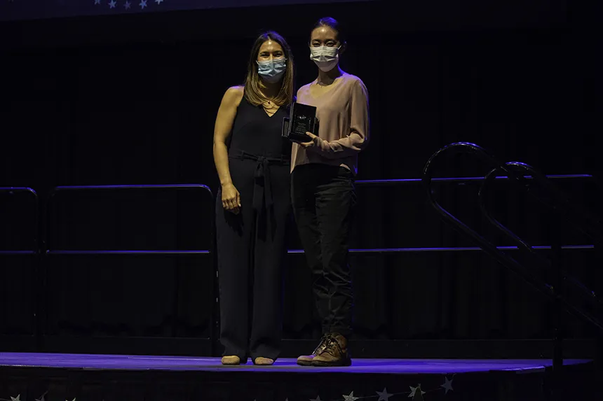 Student poses with award 