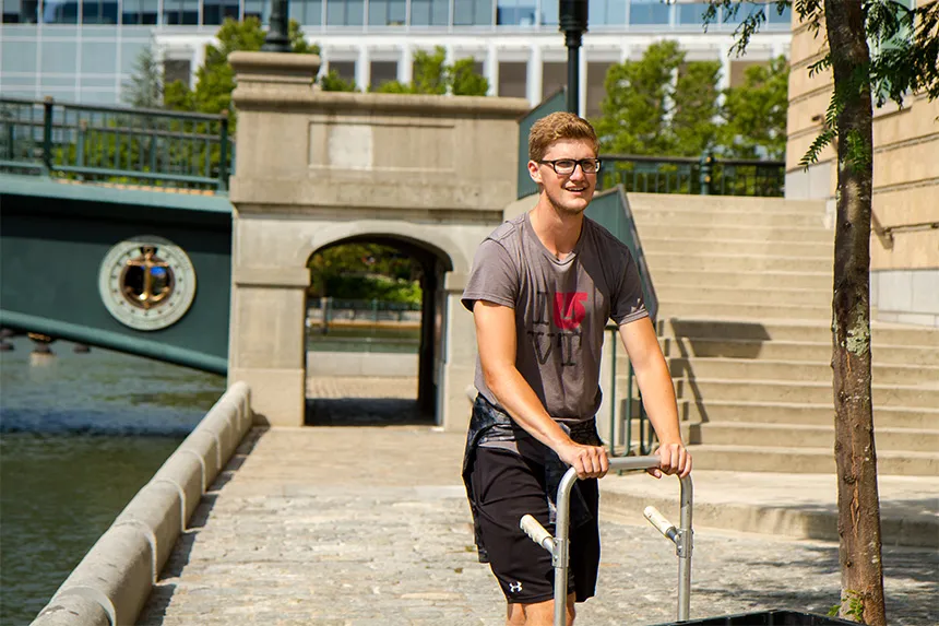 Keegan pushing a cart in downtown PVD.