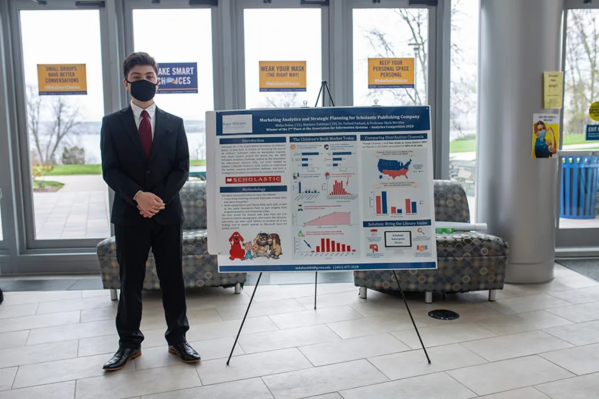 Student poses with poster