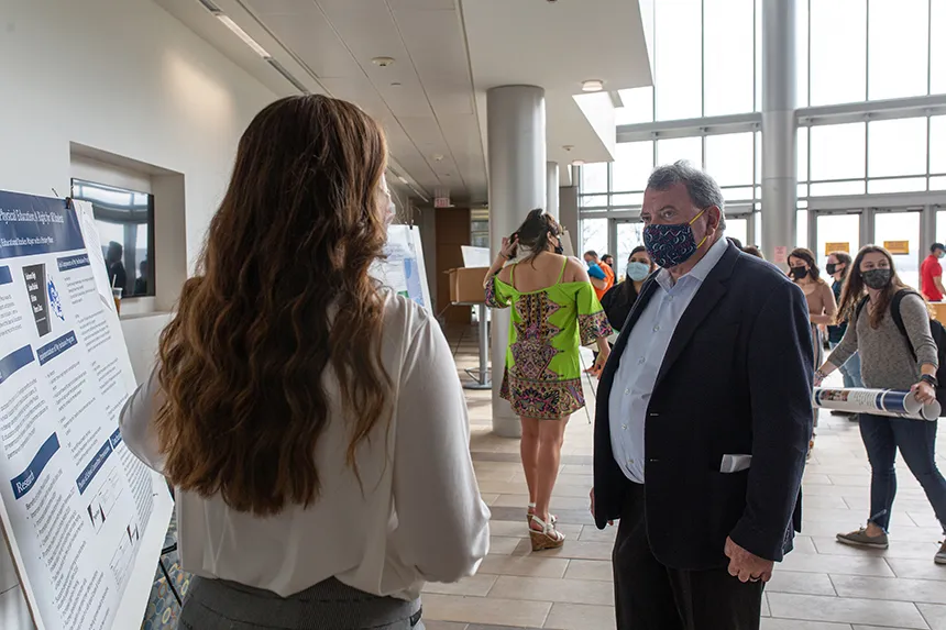 Student shares poster with President 