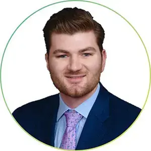 Student in a suit and tie poses for a professional headshot on a white background.